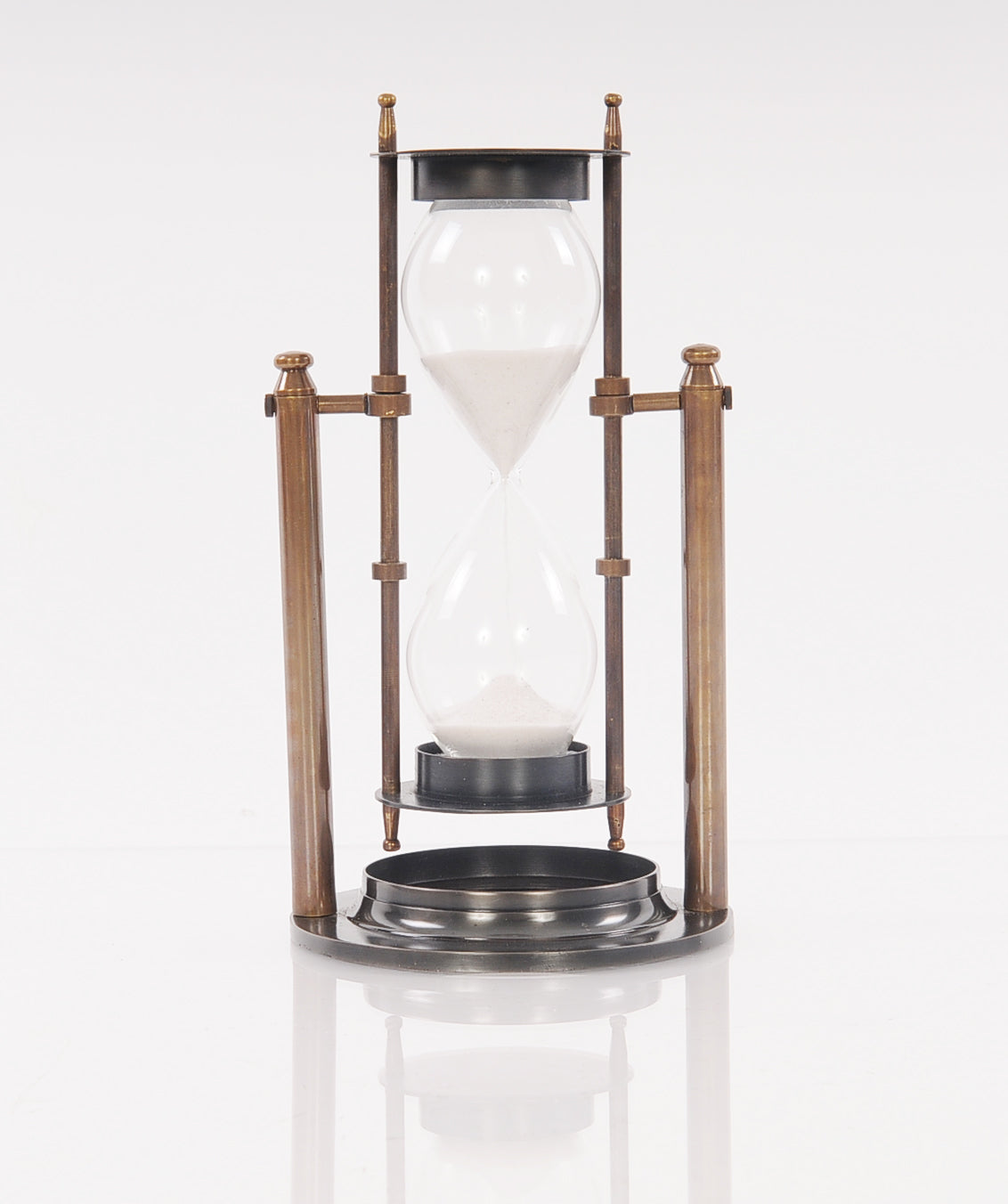 A beautifully crafted brass revolving sandtimer with an antique finish, measuring 4.5x4.5x8.5 inches, showcasing flowing sand.