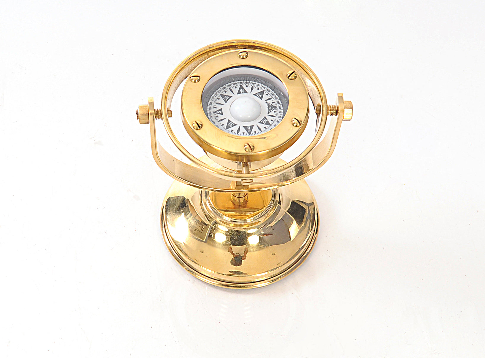 A beautifully crafted gimbaled compass made of high-quality brass with a shiny finish, measuring 4.5 inches wide, 5 inches long, and 5.5 inches high.