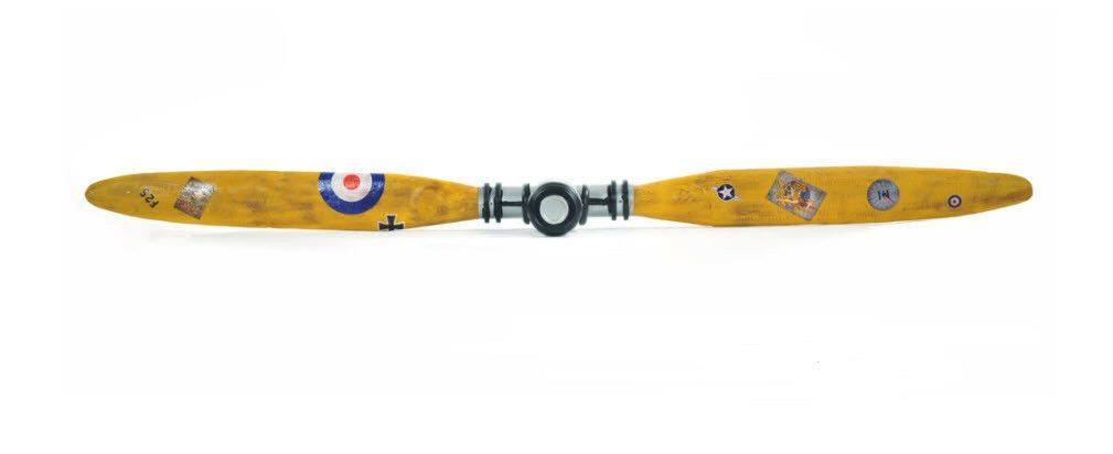 A vintage-style wooden airplane propeller measuring 4.5 inches by 79 inches by 10 inches, featuring brass accents and intricate designs, perfect for decor.