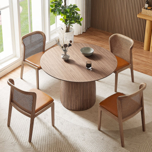 A stylish 47.24 inch round dining table with a walnut MDF top, suitable for 4-6 people, set in a cozy dining room.