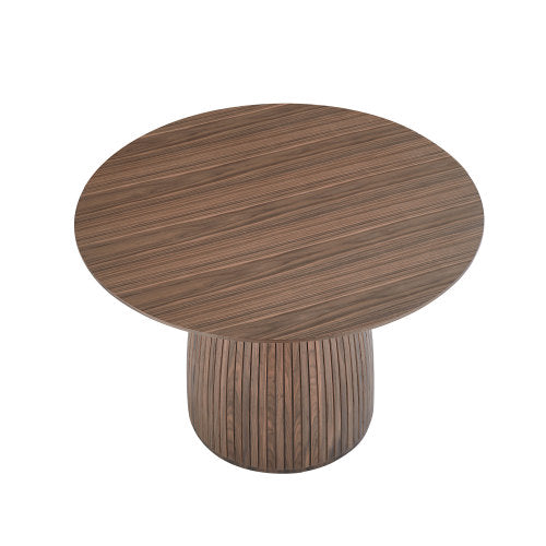 A stylish 47.24 inch round dining table with a walnut MDF top, suitable for 4-6 people, set in a cozy dining room.