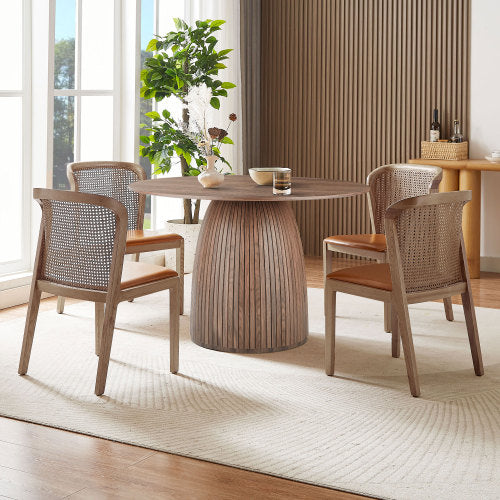 A stylish 47.24 inch round dining table with a walnut MDF top, suitable for 4-6 people, set in a cozy dining room.