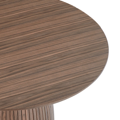 A stylish 47.24 inch round dining table with a walnut MDF top, suitable for 4-6 people, set in a cozy dining room.