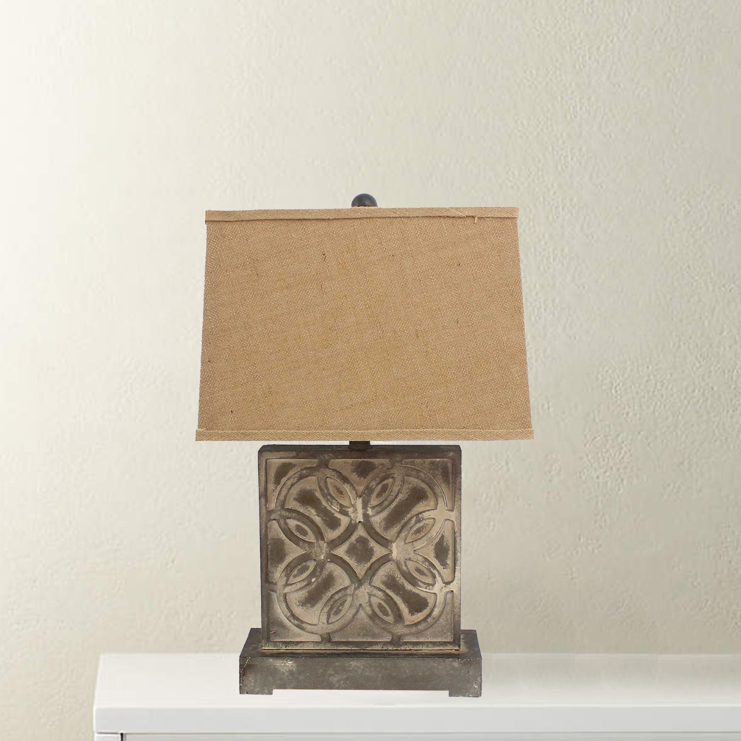 A vintage table lamp featuring a brown hammered metal base and a khaki linen shade, perfect for home decor.