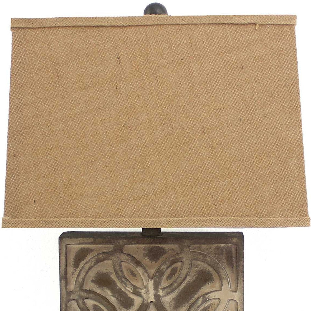 A vintage table lamp featuring a brown hammered metal base and a khaki linen shade, perfect for home decor.