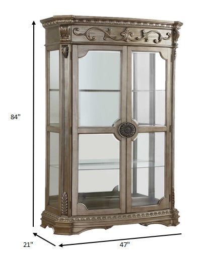 Antique Champagne Curio Cabinet with glass doors and intricate carvings, showcasing elegant design and ample display space.