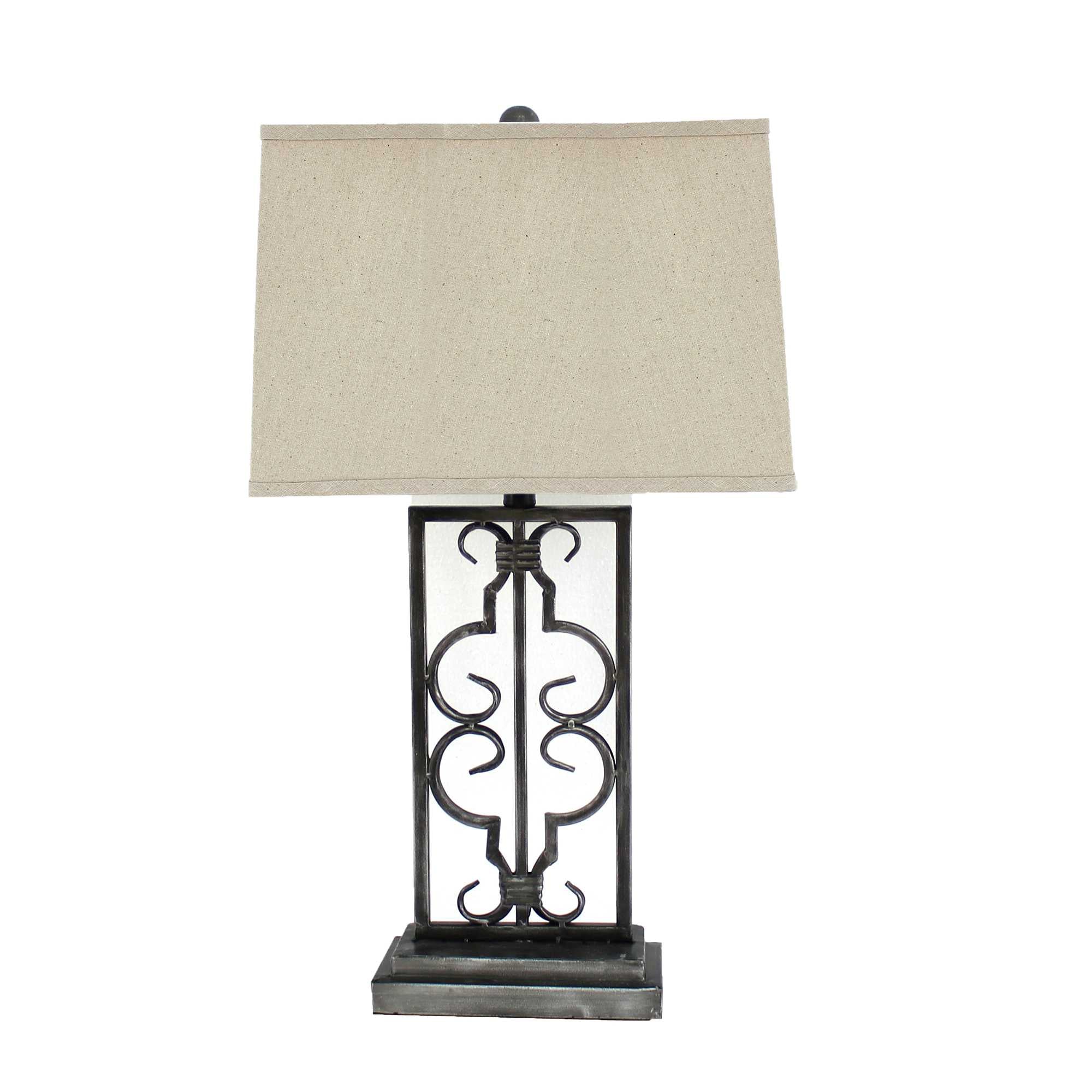 Gray industrial table lamp with stacked metal pedestal and beige linen shade, illuminating a stylish living space.