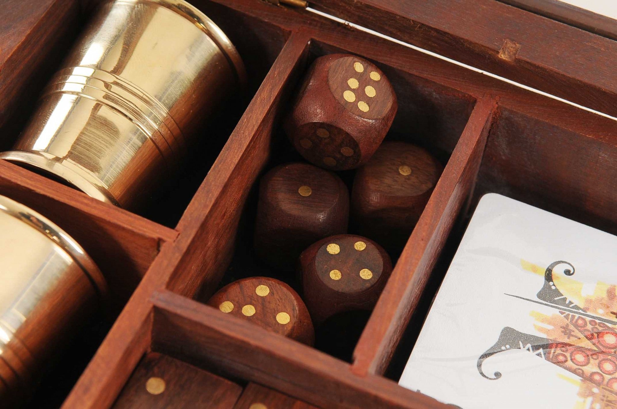 5.25 inches x 8 inches x 2.5 inches wooden game set featuring dice, dominoes, cards, and two brass goblets, elegantly crafted for family entertainment.