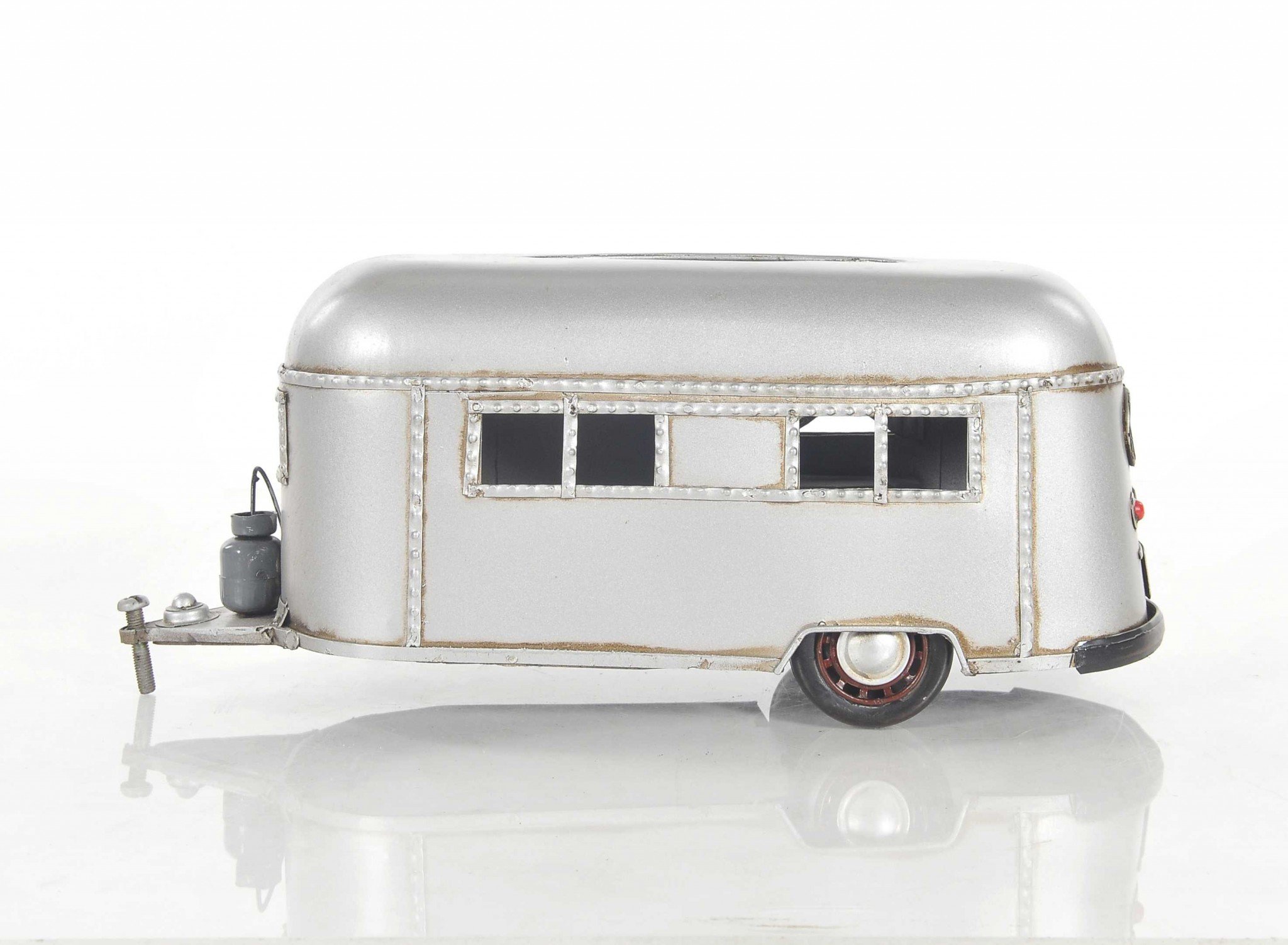 A charming 5x12x4.5 inches camping trailer tissue holder made of metal, featuring movable wheels and a hidden door for easy tissue access.