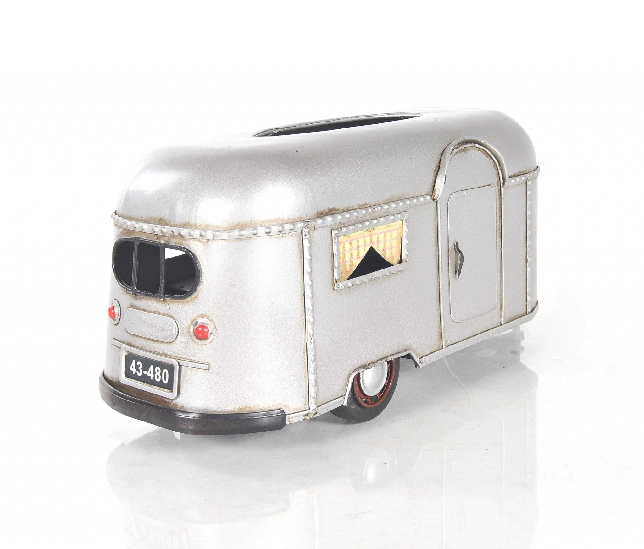 A charming 5x12x4.5 inches camping trailer tissue holder made of metal, featuring movable wheels and a hidden door for easy tissue access.