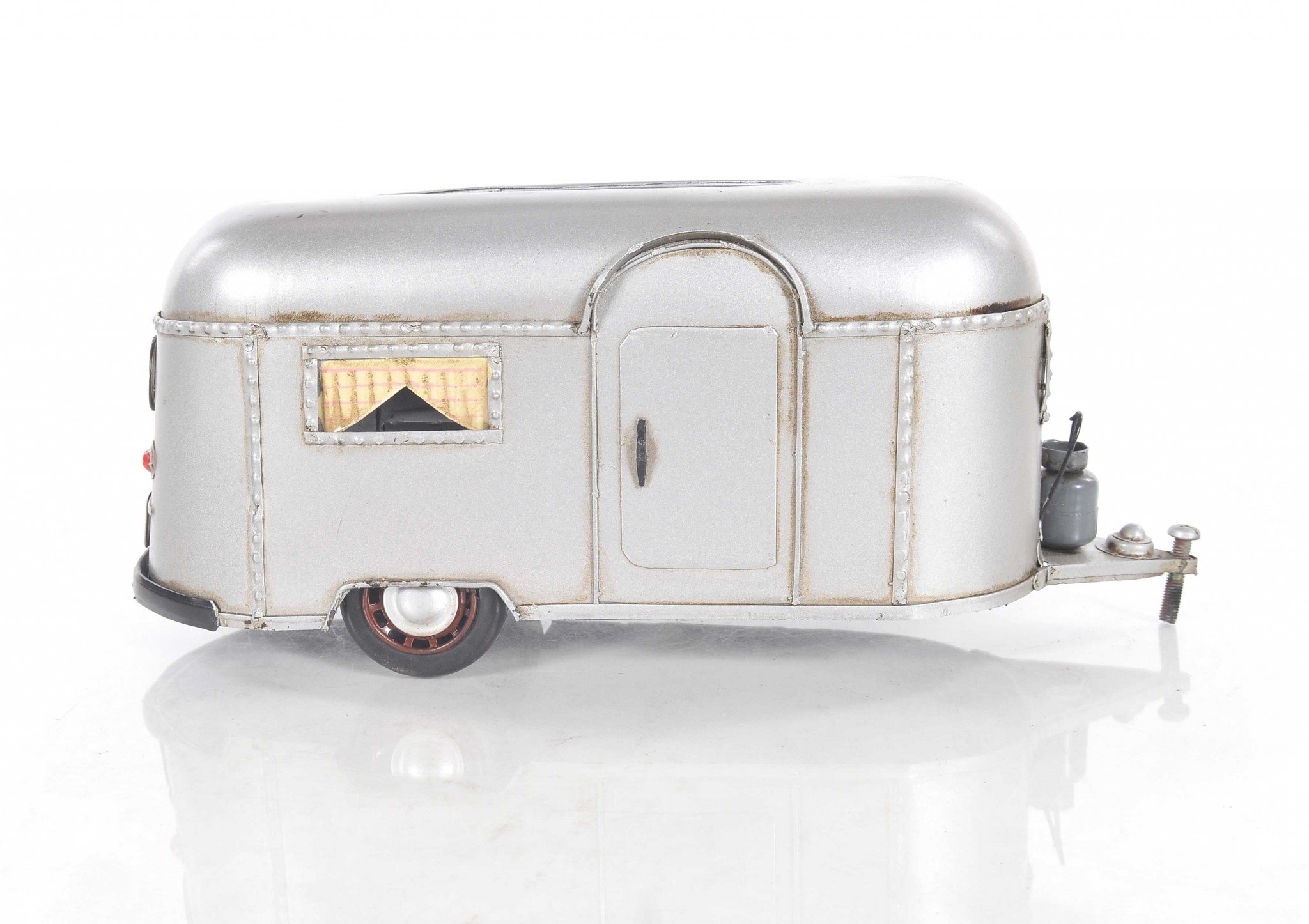 A charming 5x12x4.5 inches camping trailer tissue holder made of metal, featuring movable wheels and a hidden door for easy tissue access.