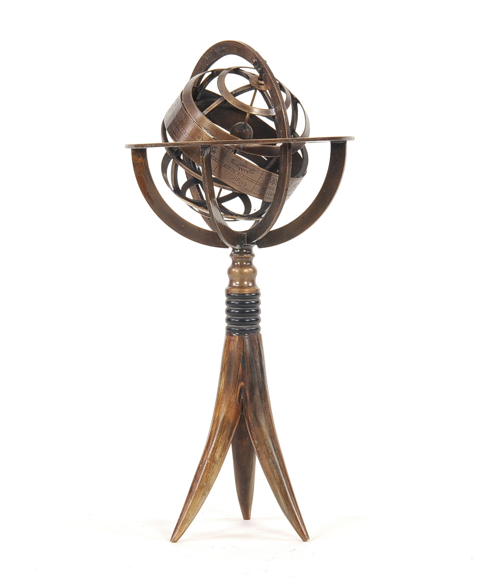 A beautifully crafted brass armillary globe on a buffalo horn stand, showcasing intricate details and a spinning interior.