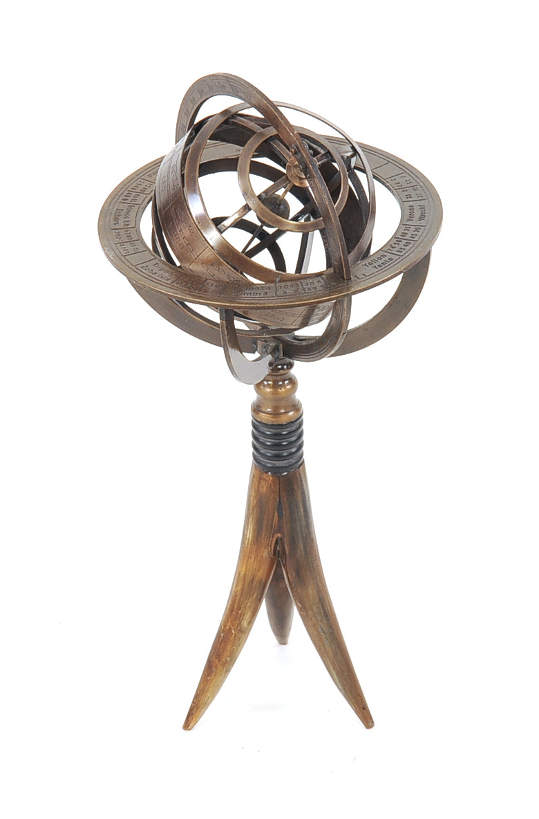 A beautifully crafted brass armillary globe on a buffalo horn stand, showcasing intricate details and a spinning interior.