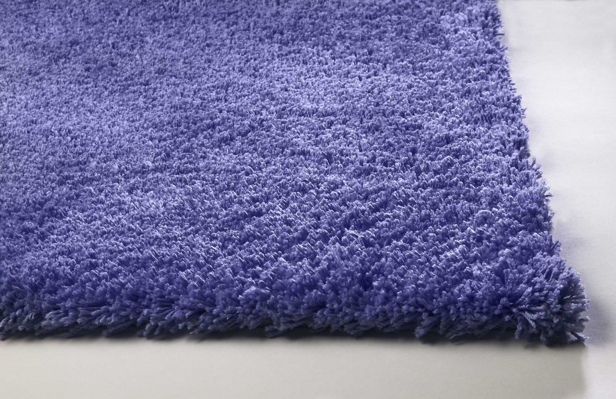 A vibrant purple shag rug measuring 5x7 inches, showcasing a soft texture and contemporary design, perfect for indoor use.