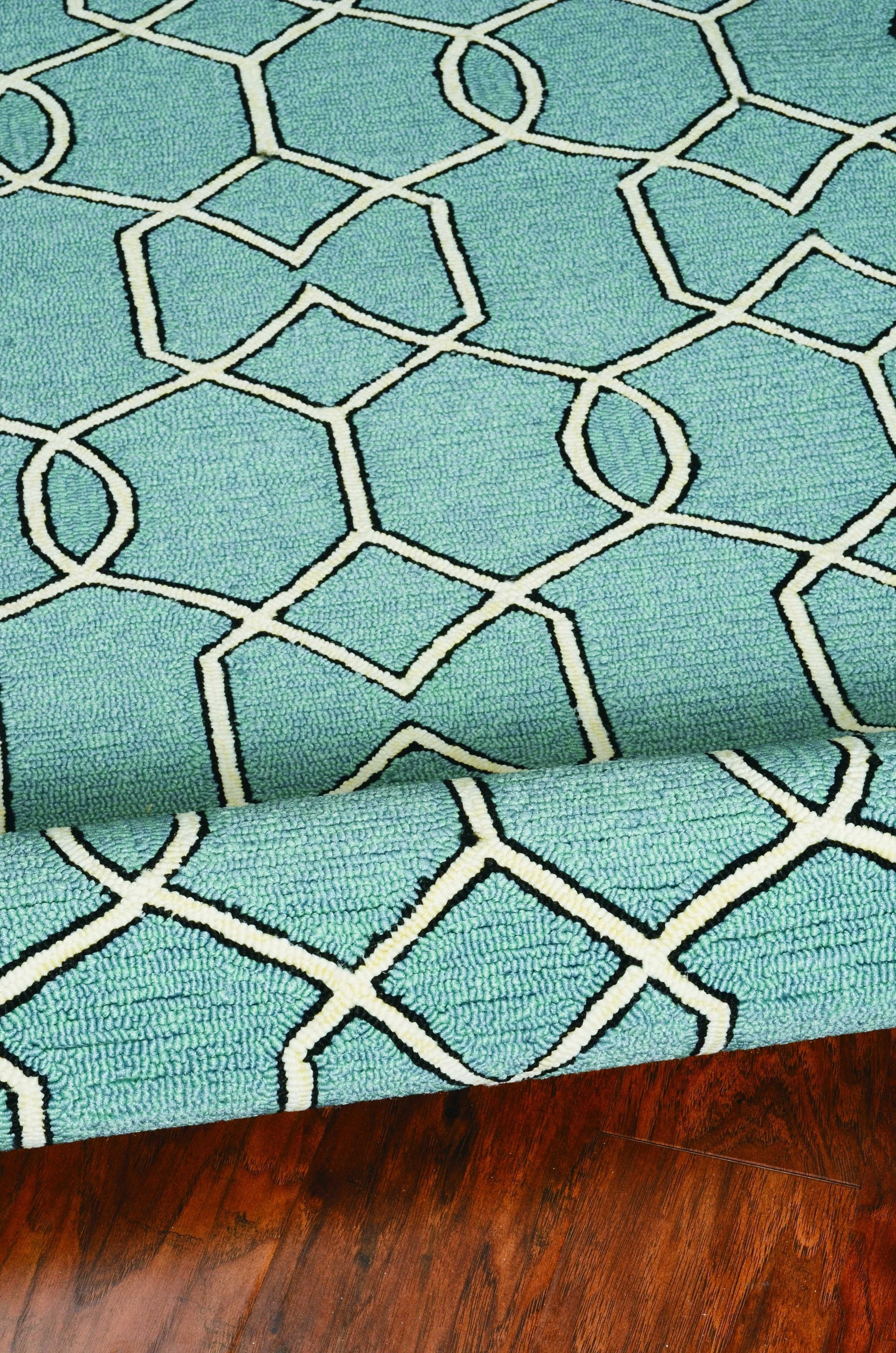 5x7 spa geometric trellis indoor area rug in soothing green color, showcasing intricate hand-hooked design and modern aesthetic.