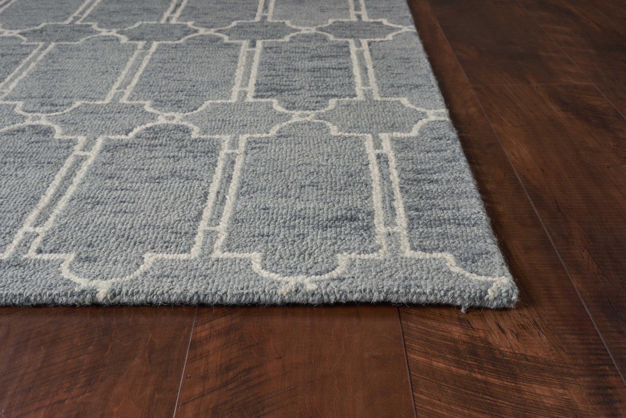 A beautiful blue hand-tufted wool herringbone indoor area rug measuring 5x7 inches, showcasing a modern design and high-quality craftsmanship.