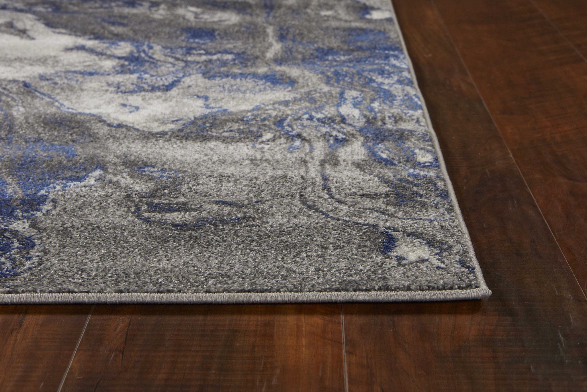 5x8 grey machine woven abstract watercolor indoor area rug showcasing modern design and soft texture.