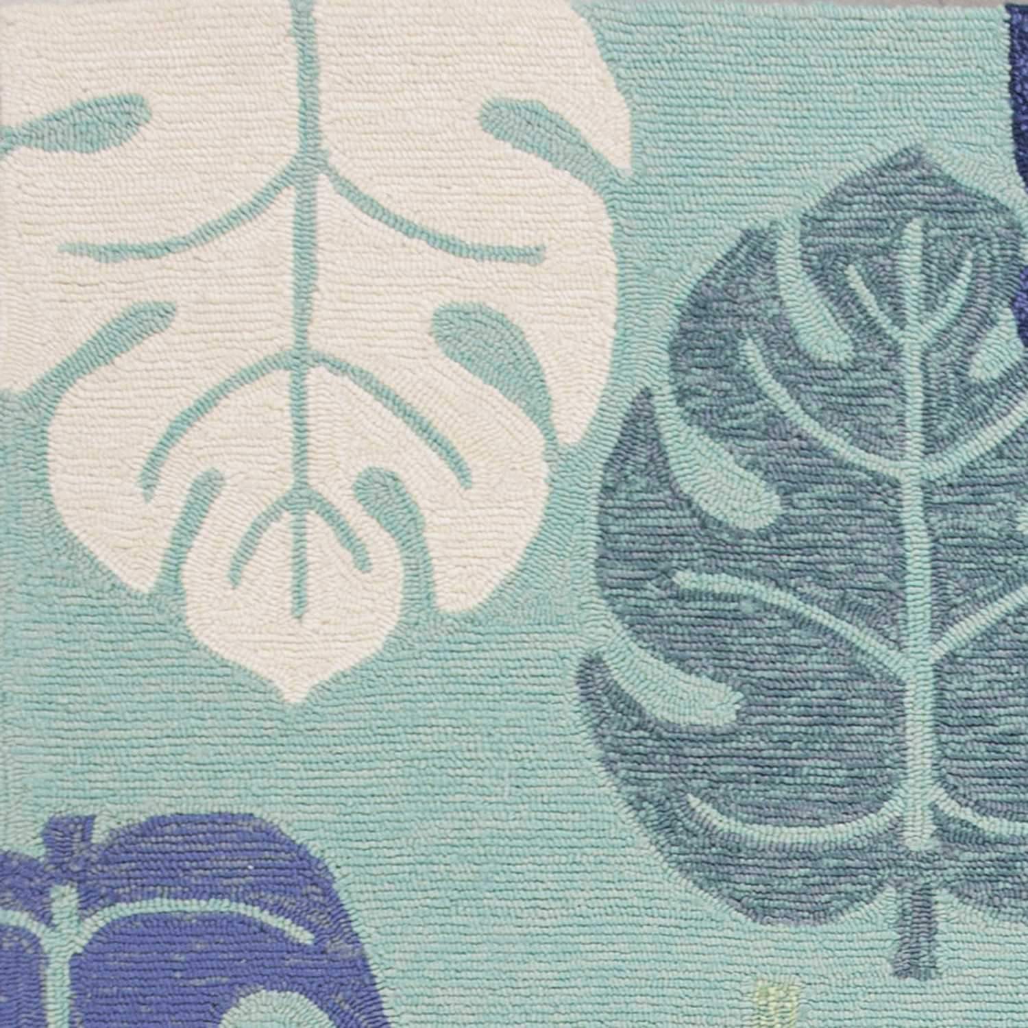 A vibrant turquoise blue hand hooked rug featuring tropical leaves design, suitable for indoor and outdoor use.