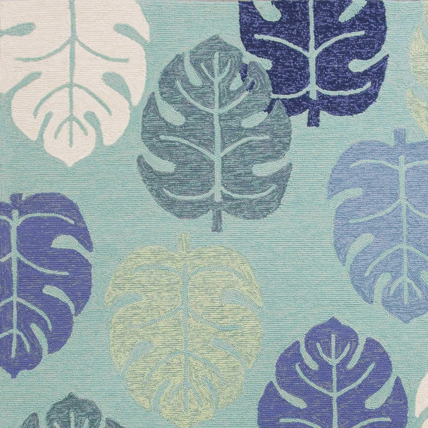 A vibrant turquoise blue hand hooked rug featuring tropical leaves design, suitable for indoor and outdoor use.