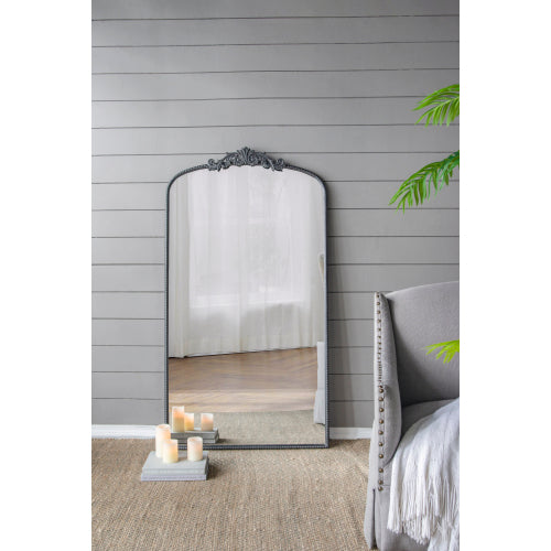 A stylish 66" x 36" full-length arched mirror with a black frame and regal adornment, perfect for hanging or leaning against a wall.