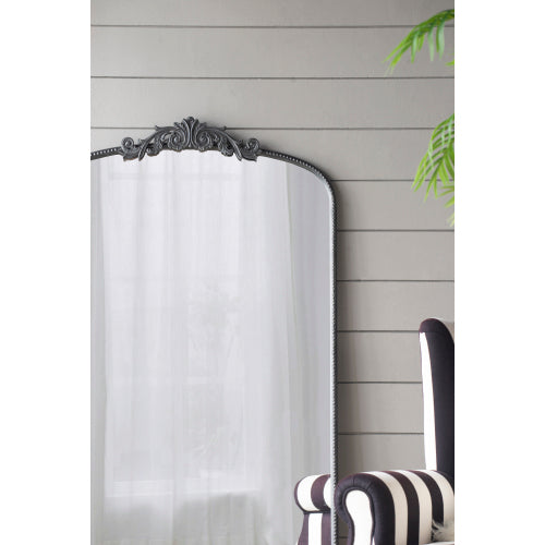 A stylish 66" x 36" full-length arched mirror with a black frame and regal adornment, perfect for hanging or leaning against a wall.