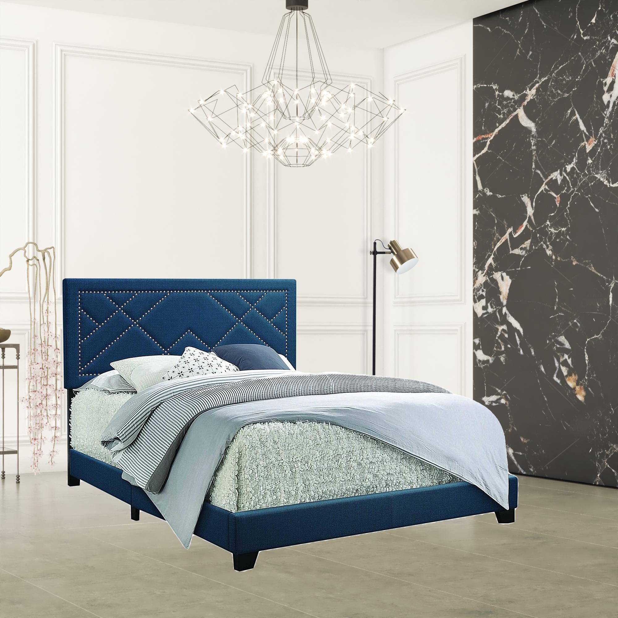 A dark teal fabric upholstered bed featuring a padded headboard with chrome nailhead trim and a low-profile footboard, set in a stylish bedroom.