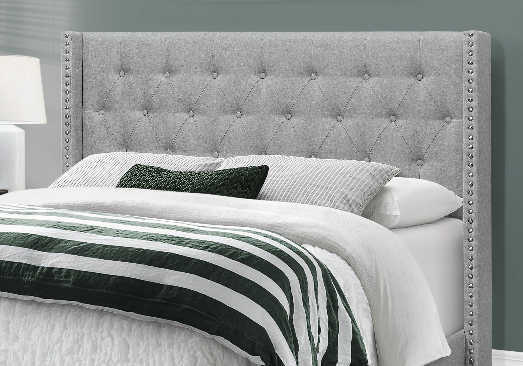 A contemporary grey queen size bed made of solid wood and foam, featuring a linen finish and elegant design, perfect for modern bedrooms.