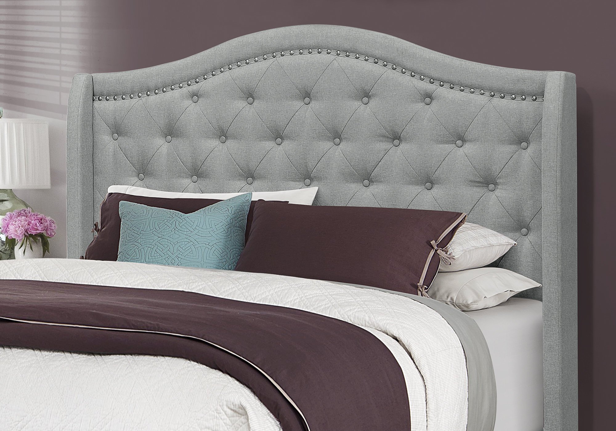 Luxurious grey linen queen size bed frame with chrome trim and wing back headboard, showcasing elegant design and comfort.