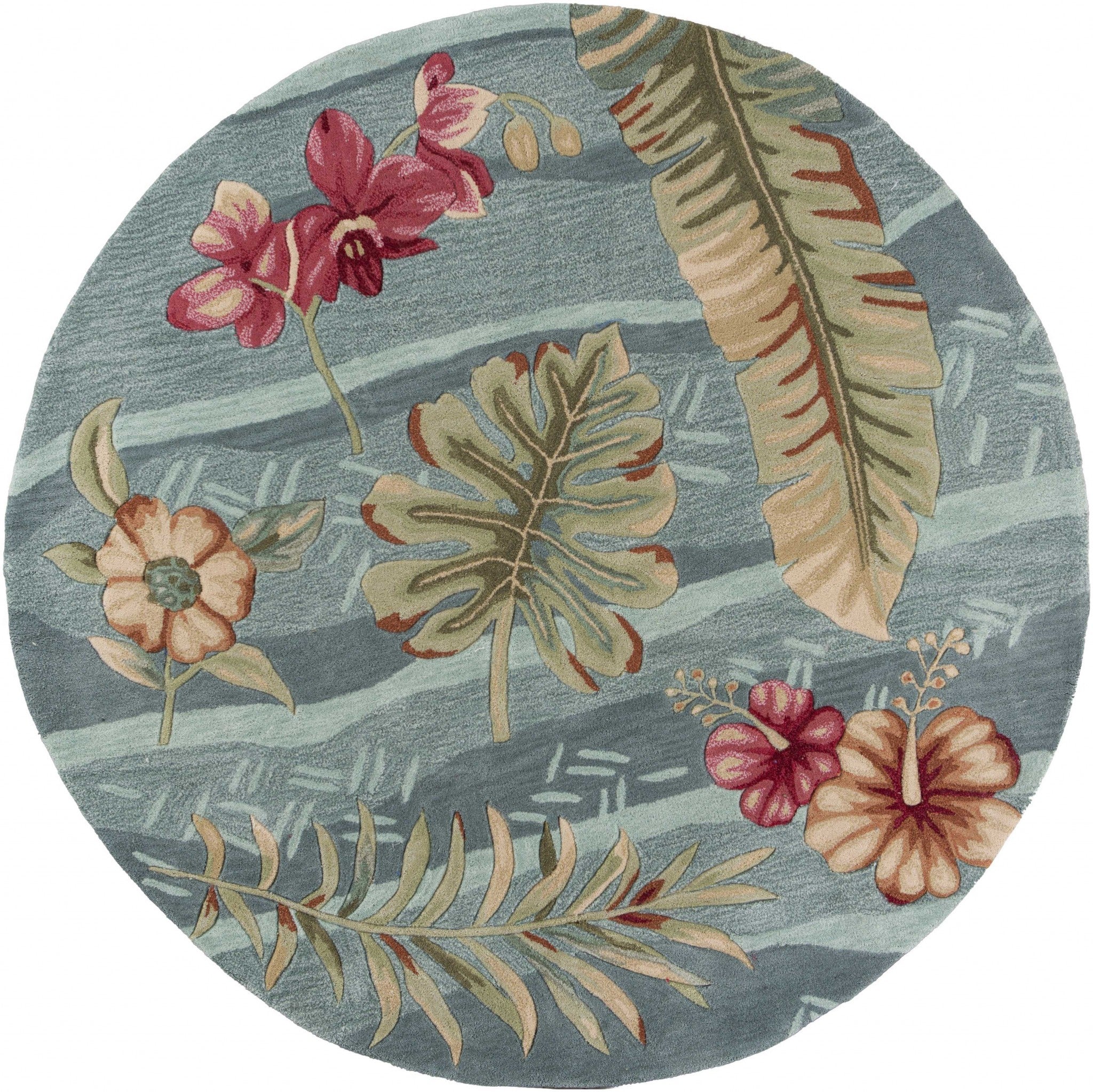 A round indoor area rug featuring a vibrant seafoam green color with tropical plant designs, hand-tufted for quality and style.