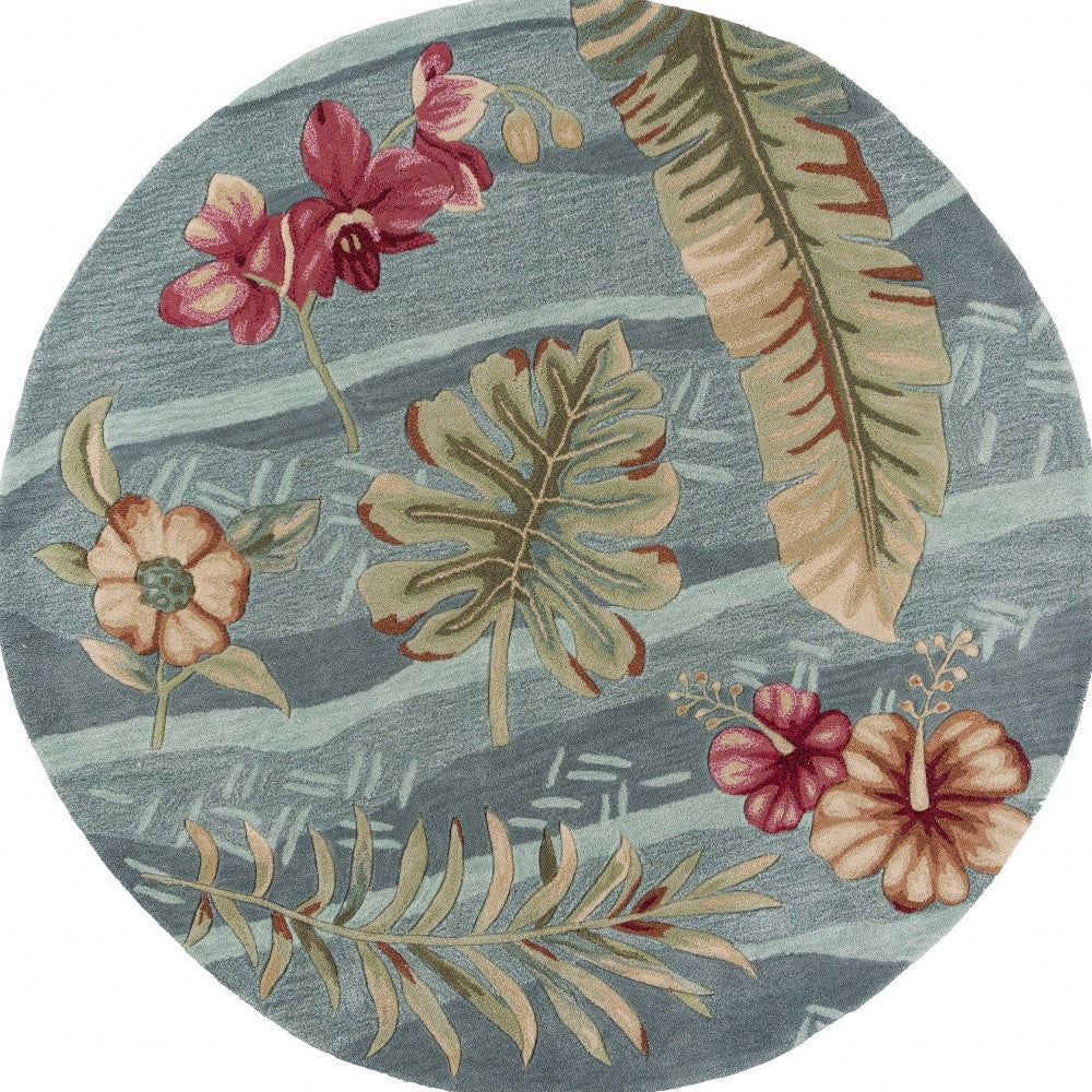 A round indoor area rug featuring a vibrant seafoam green color with tropical plant designs, hand-tufted for quality and style.