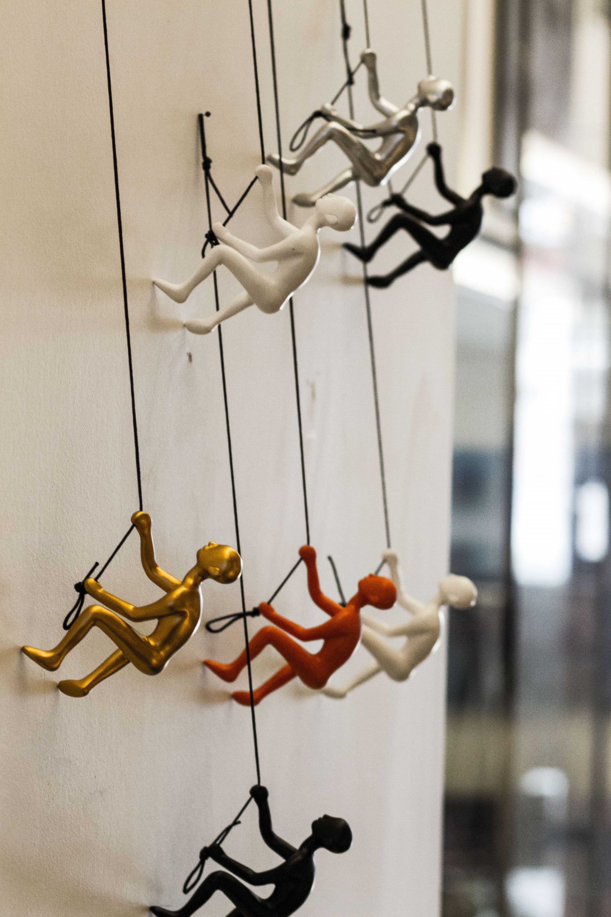 A detailed view of the Resin Gold Climbing Man wall art, showcasing its unique climbing design and elegant gold finish.