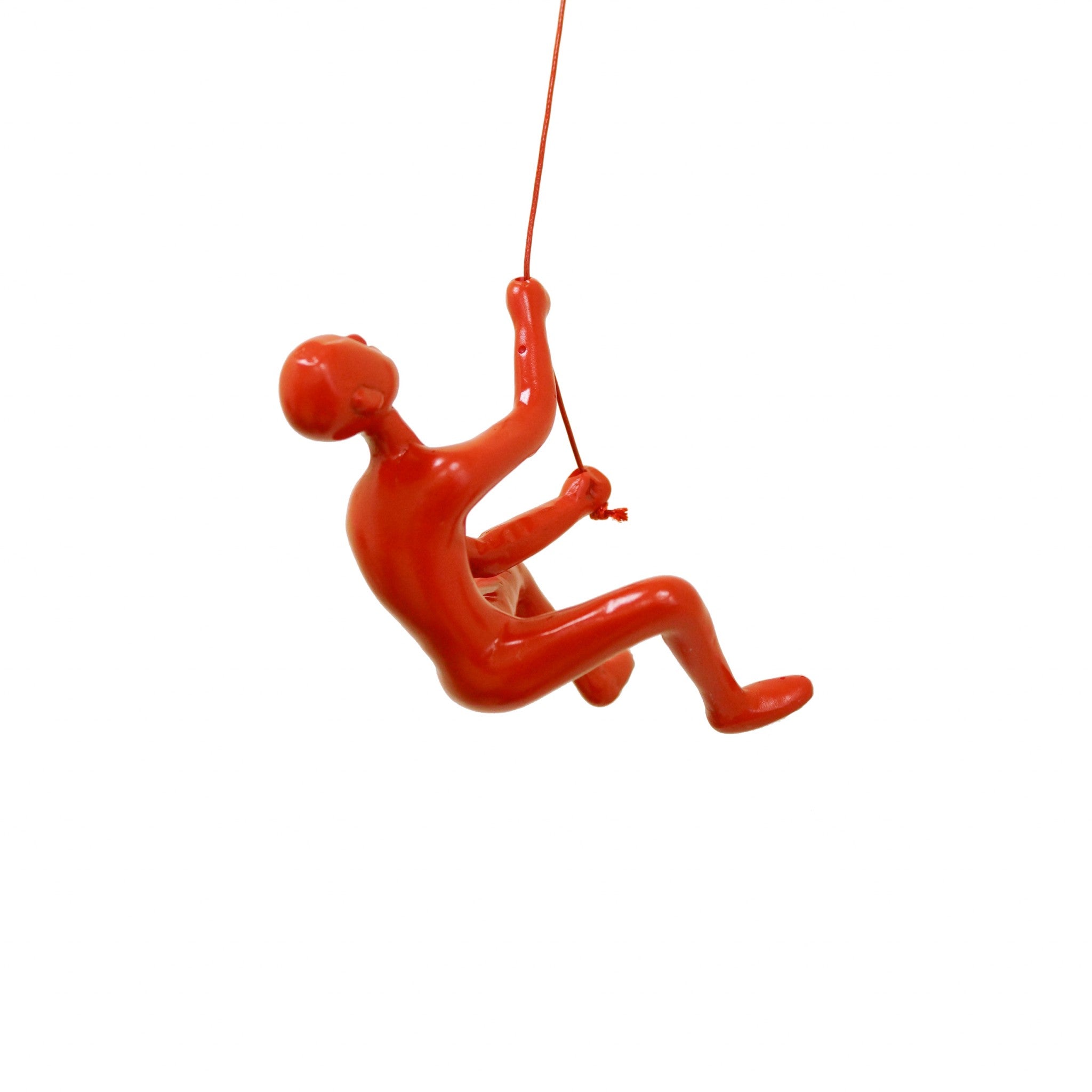 A vibrant red resin sculpture of a man climbing, showcasing a unique three-dimensional design for wall decor.