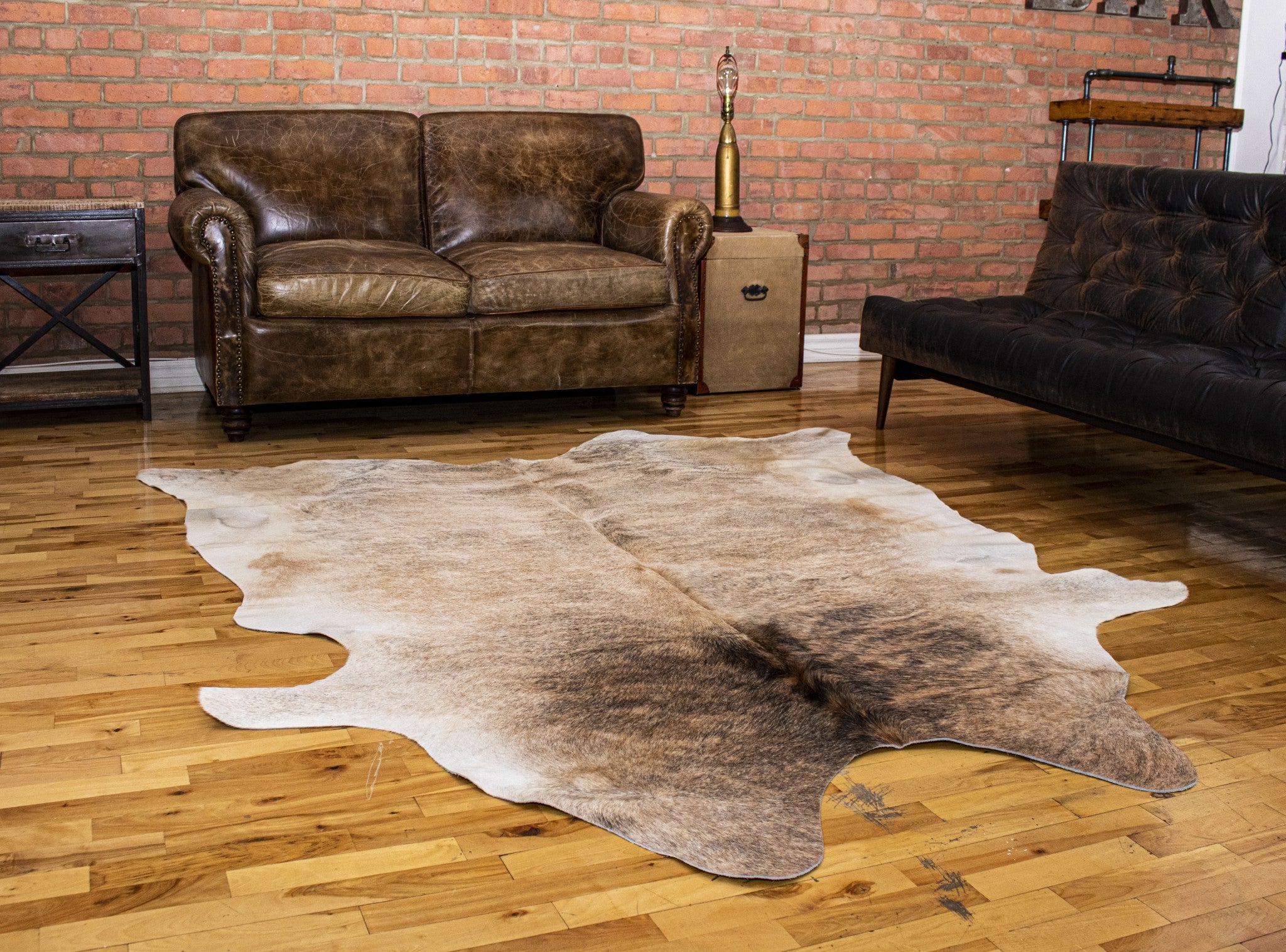 A luxurious 6x7 light taupe and brown exotic cowhide rug showcasing natural patterns and textures, perfect for enhancing home decor.