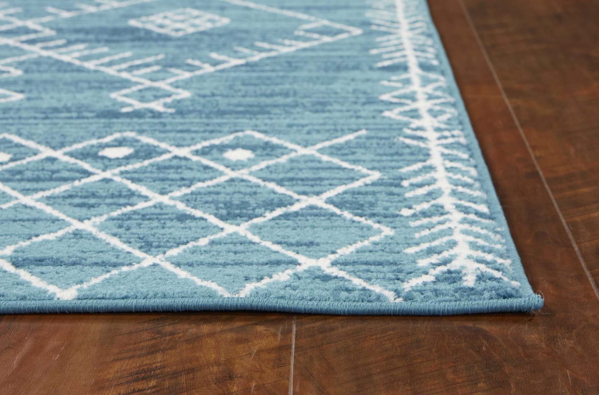 7' Ocean Blue Machine Woven Geometric Tribal Indoor Runner Rug with white geometric designs, perfect for modern decor.