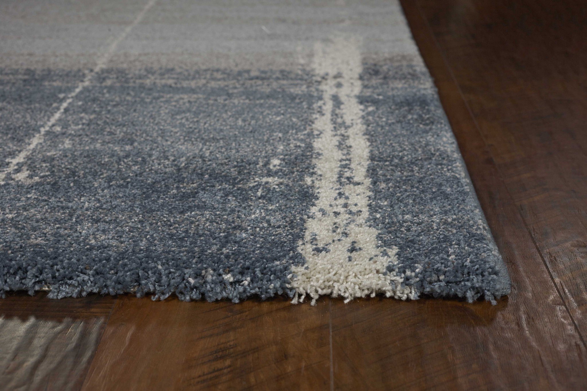 A beautiful 7 x 10 blue polypropylene area rug with a contemporary design, perfect for enhancing living spaces.