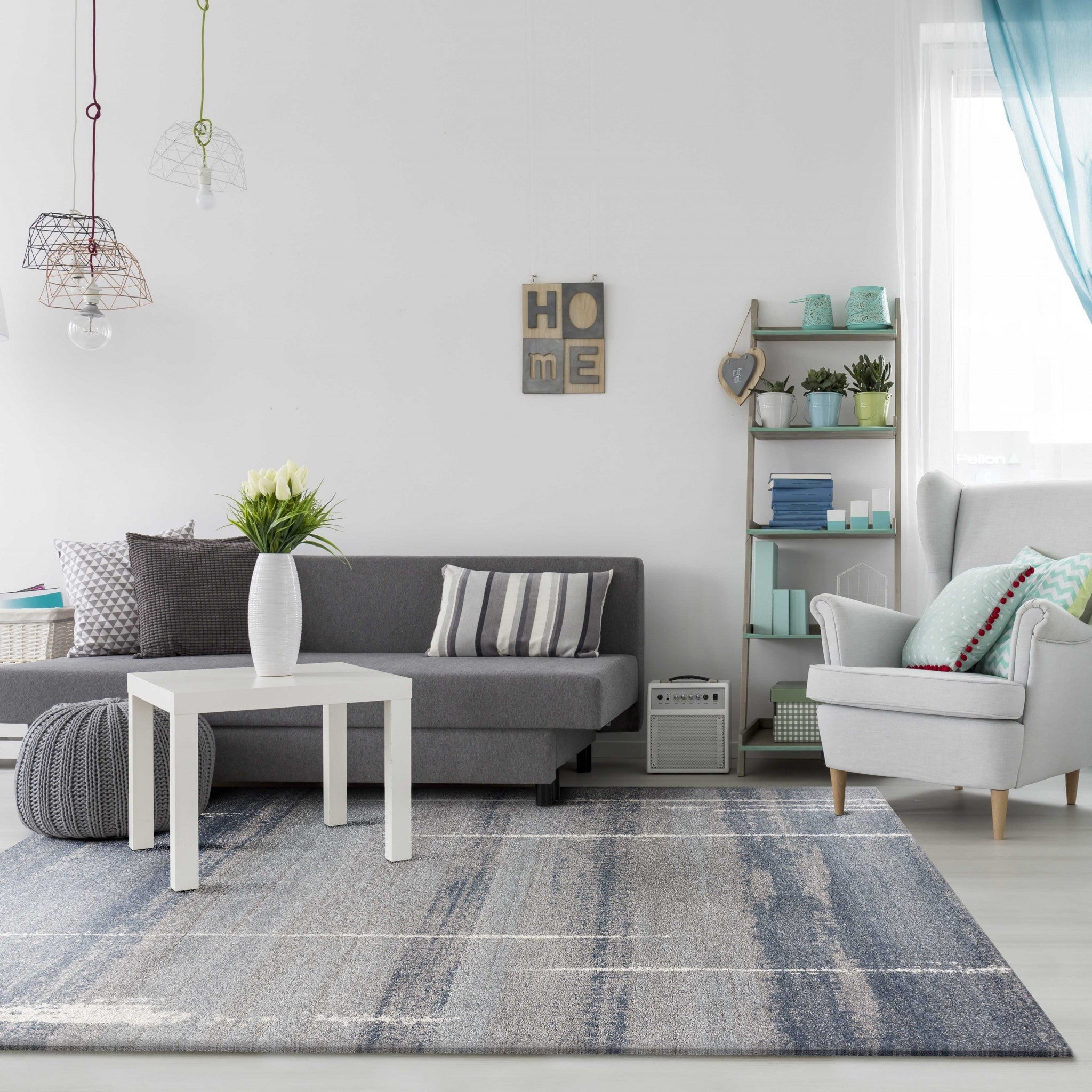 A beautiful 7 x 10 blue polypropylene area rug with a contemporary design, perfect for enhancing living spaces.