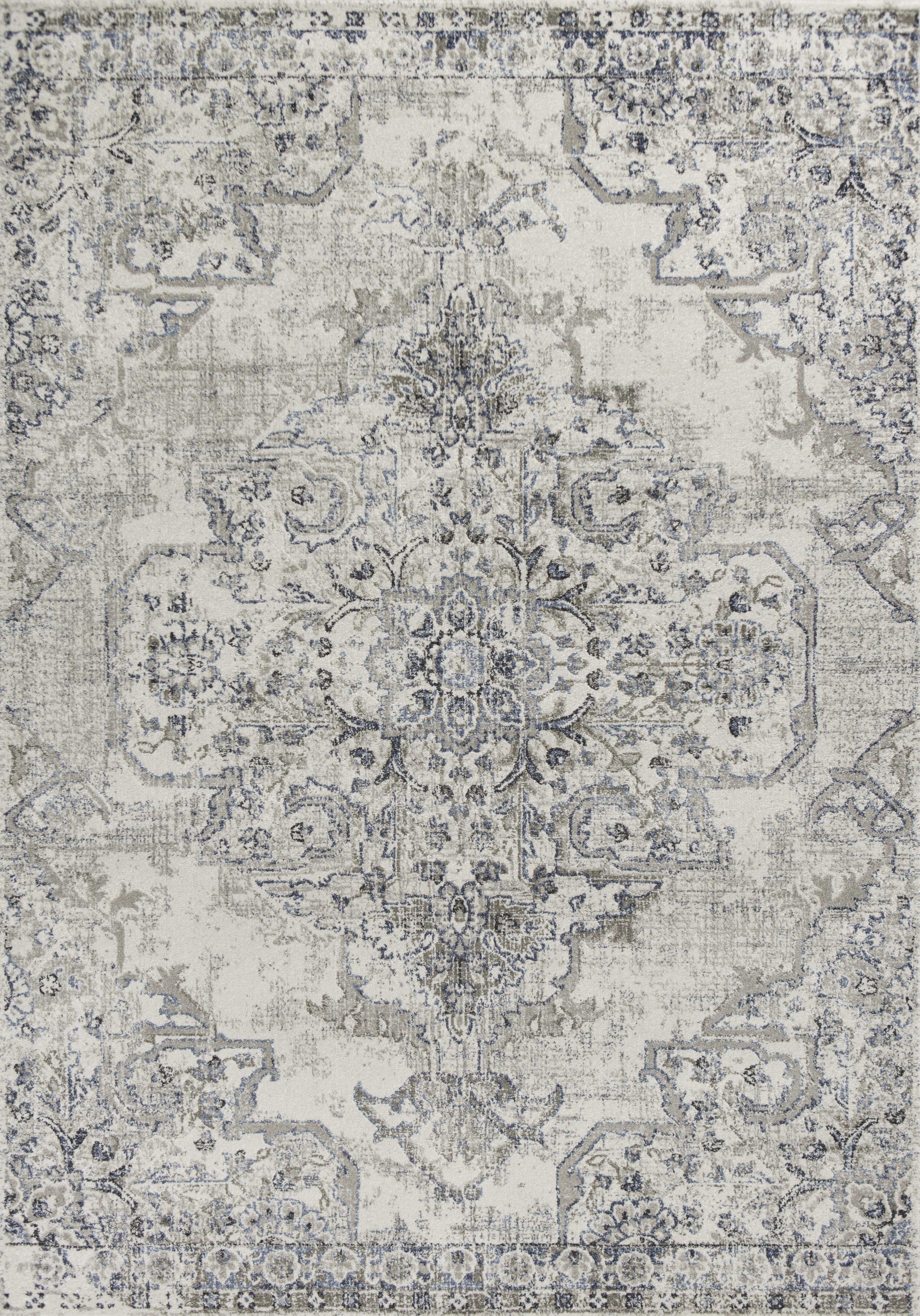 A beautiful 7 x 10 Polypropylene area rug in ivory and grey with a medallion pattern, showcasing its intricate design and soft texture.