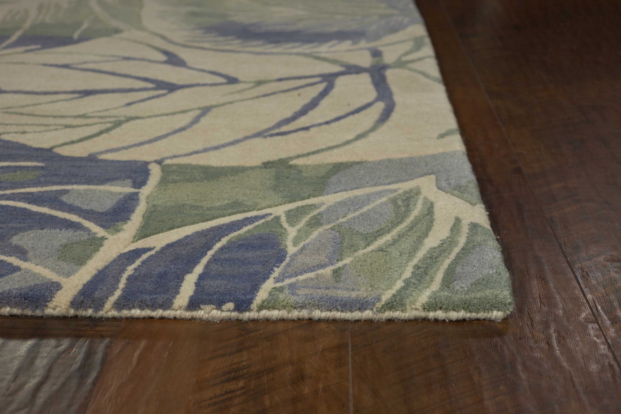 A luxurious 7x9 wool area rug in blue and green floral design, perfect for contemporary living spaces.