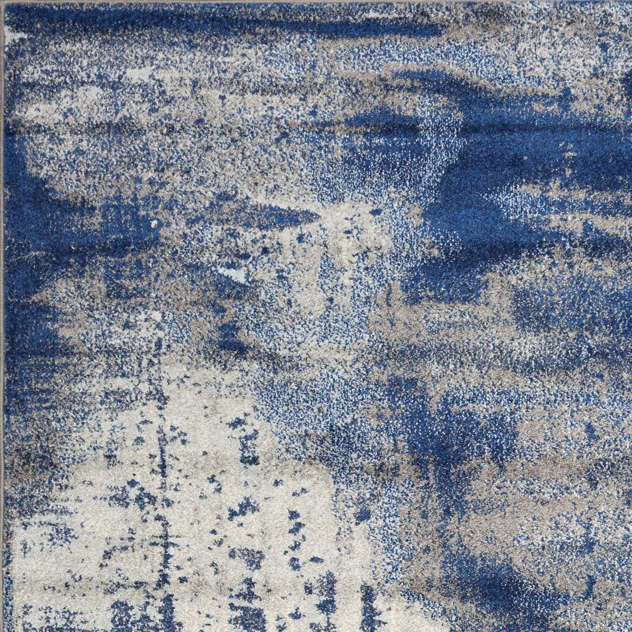 7'x10' Ice Blue Machine Woven Abstract Indoor Area Rug featuring unique watercolor patterns and soft texture.