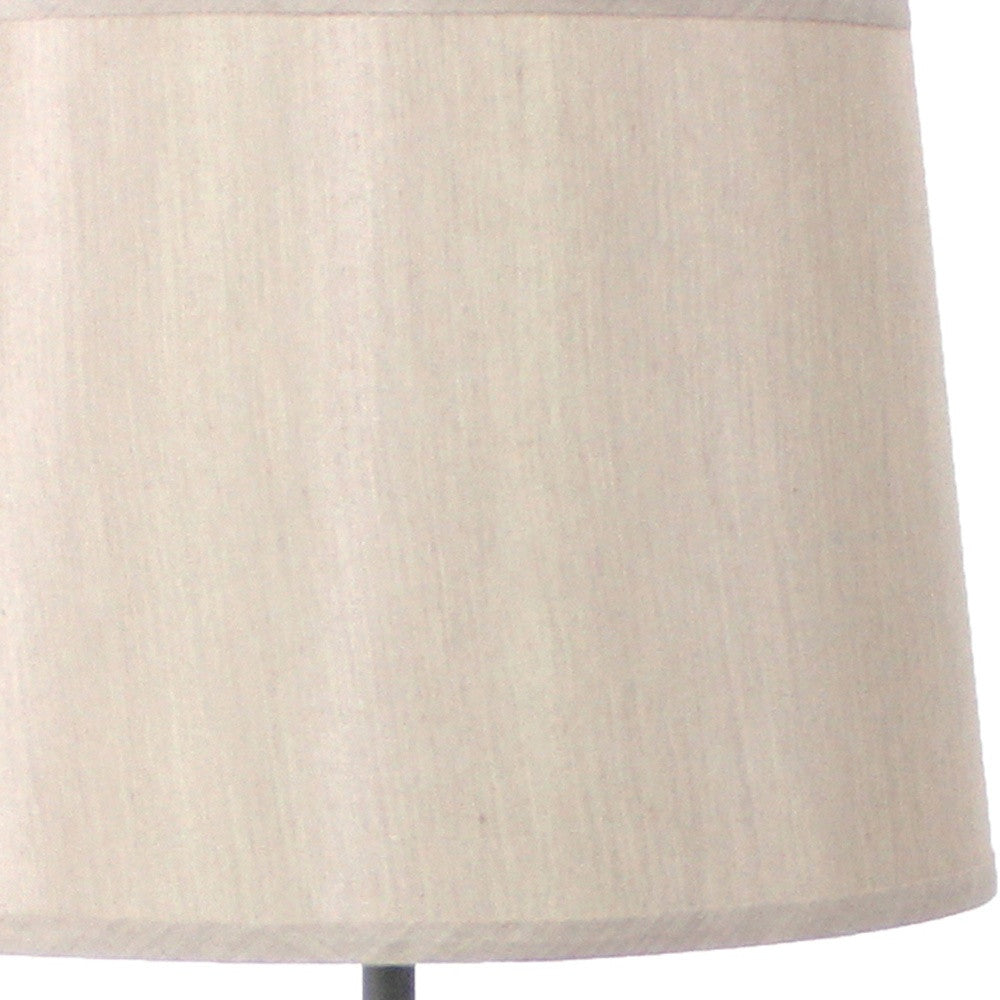 Gray rustic flowering tree table lamp with beige linen shade, showcasing a unique metal base design.