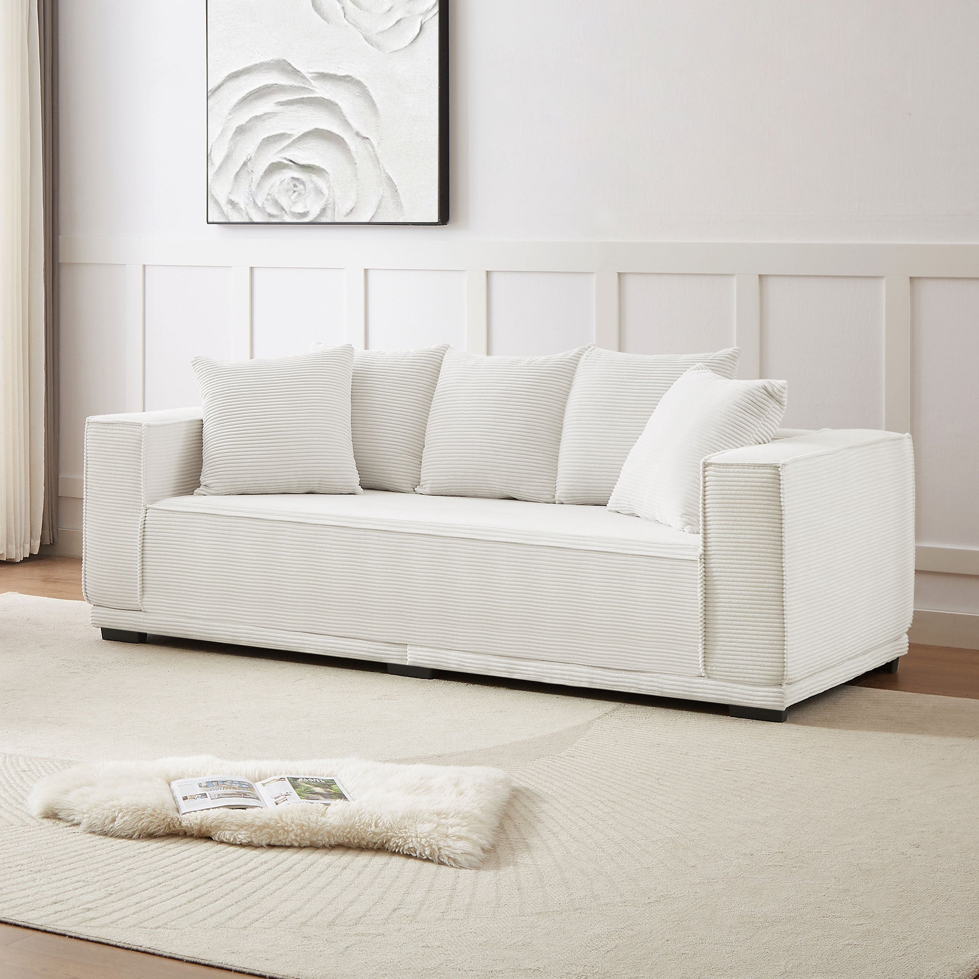 A stylish 88.97'' Mid Century Modern Upholstered Sofa in white corduroy, featuring a sleek design and five matching toss pillows, perfect for modern living rooms.