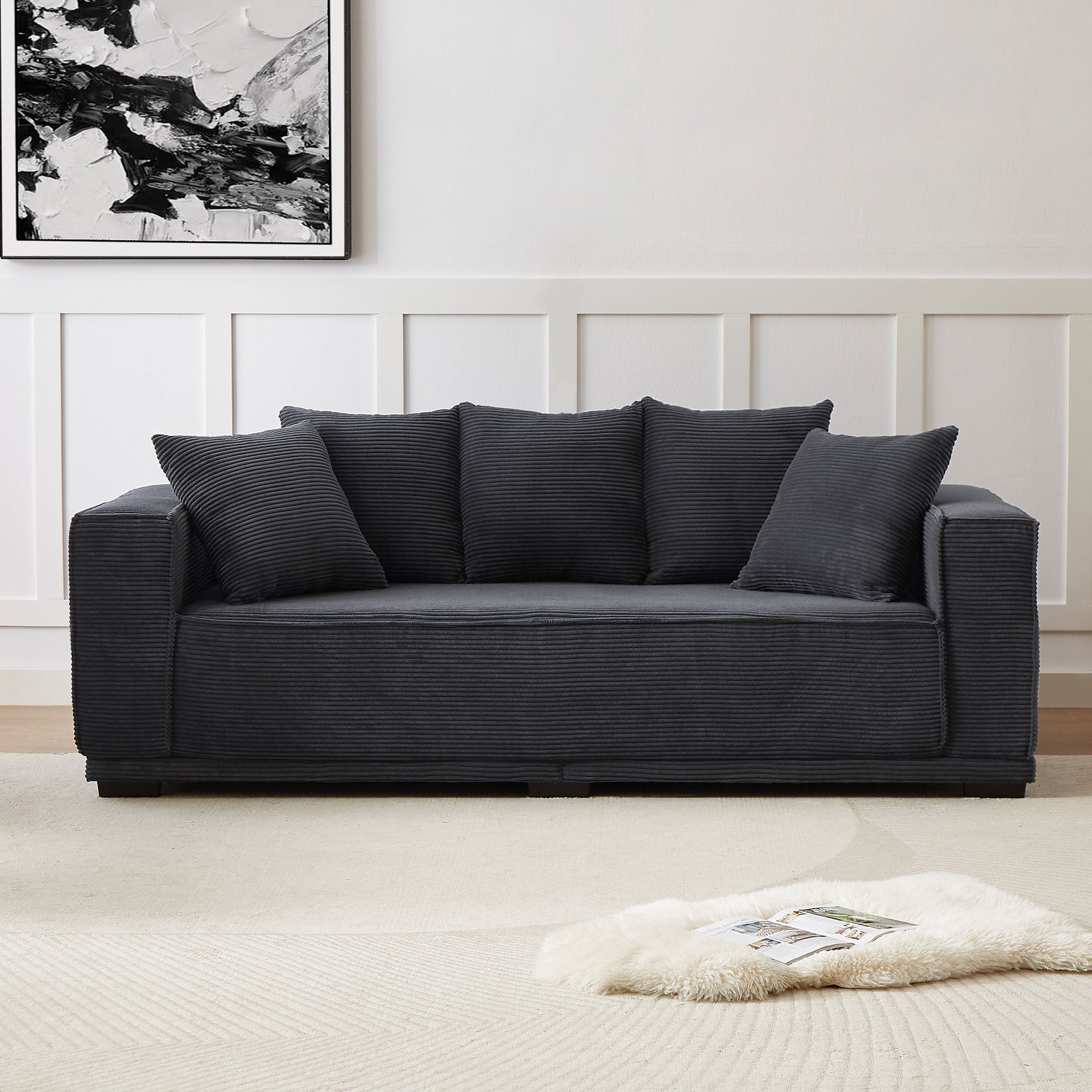 A stylish 88.97'' Mid Century Modern Upholstered Sofa in black corduroy with five matching toss pillows, perfect for contemporary living spaces.