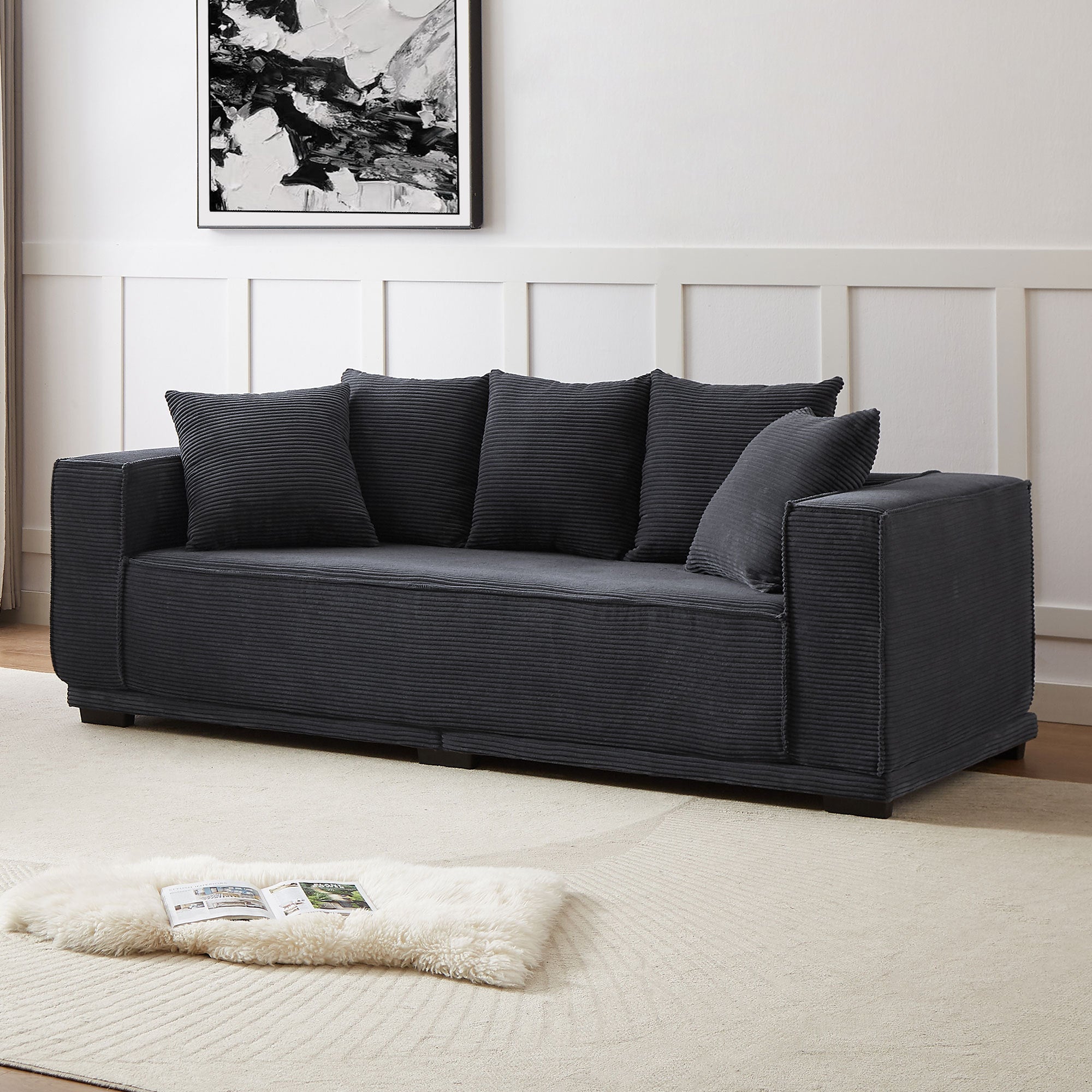 A stylish 88.97'' Mid Century Modern Upholstered Sofa in black corduroy with five matching toss pillows, perfect for contemporary living spaces.