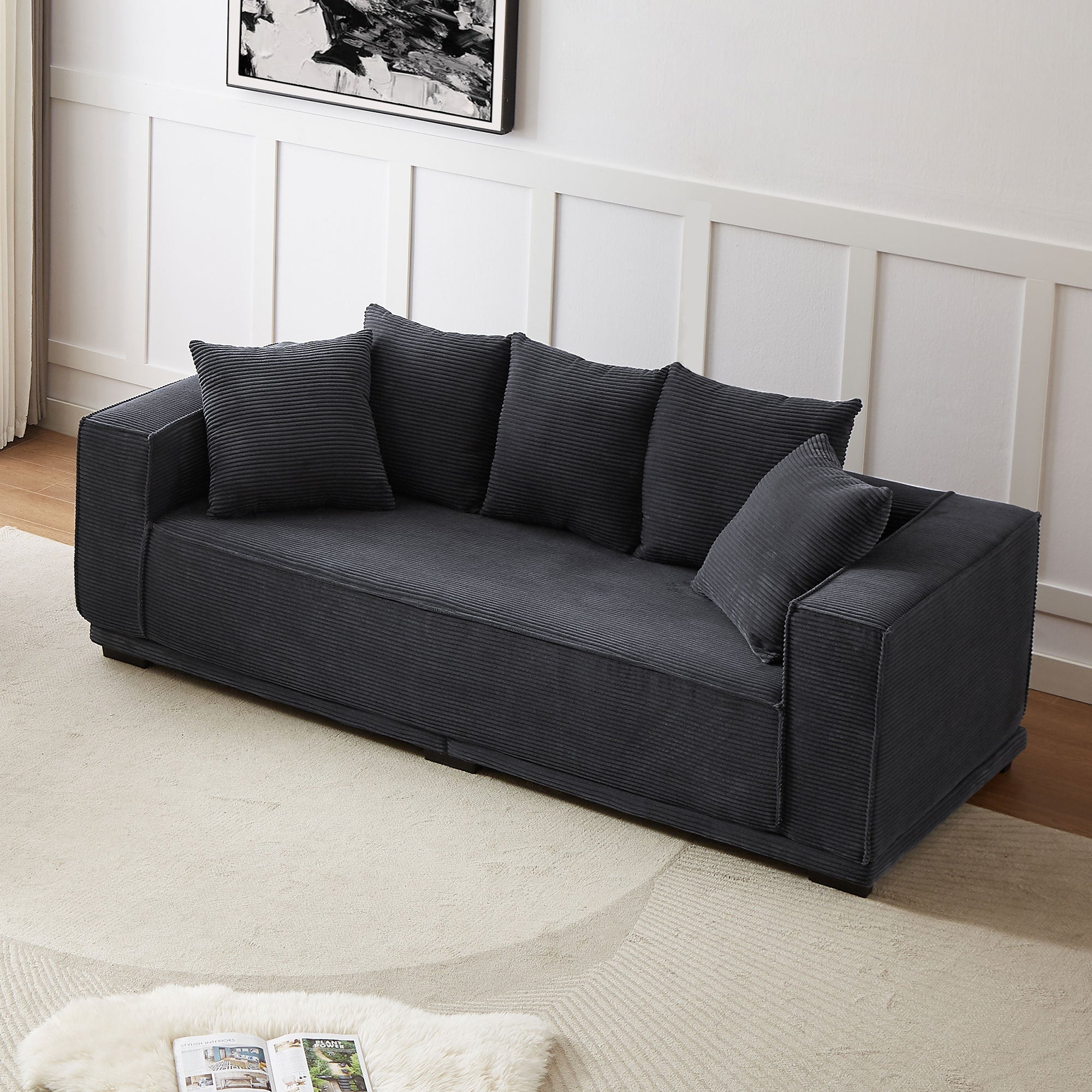 A stylish 88.97'' Mid Century Modern Upholstered Sofa in black corduroy with five matching toss pillows, perfect for contemporary living spaces.