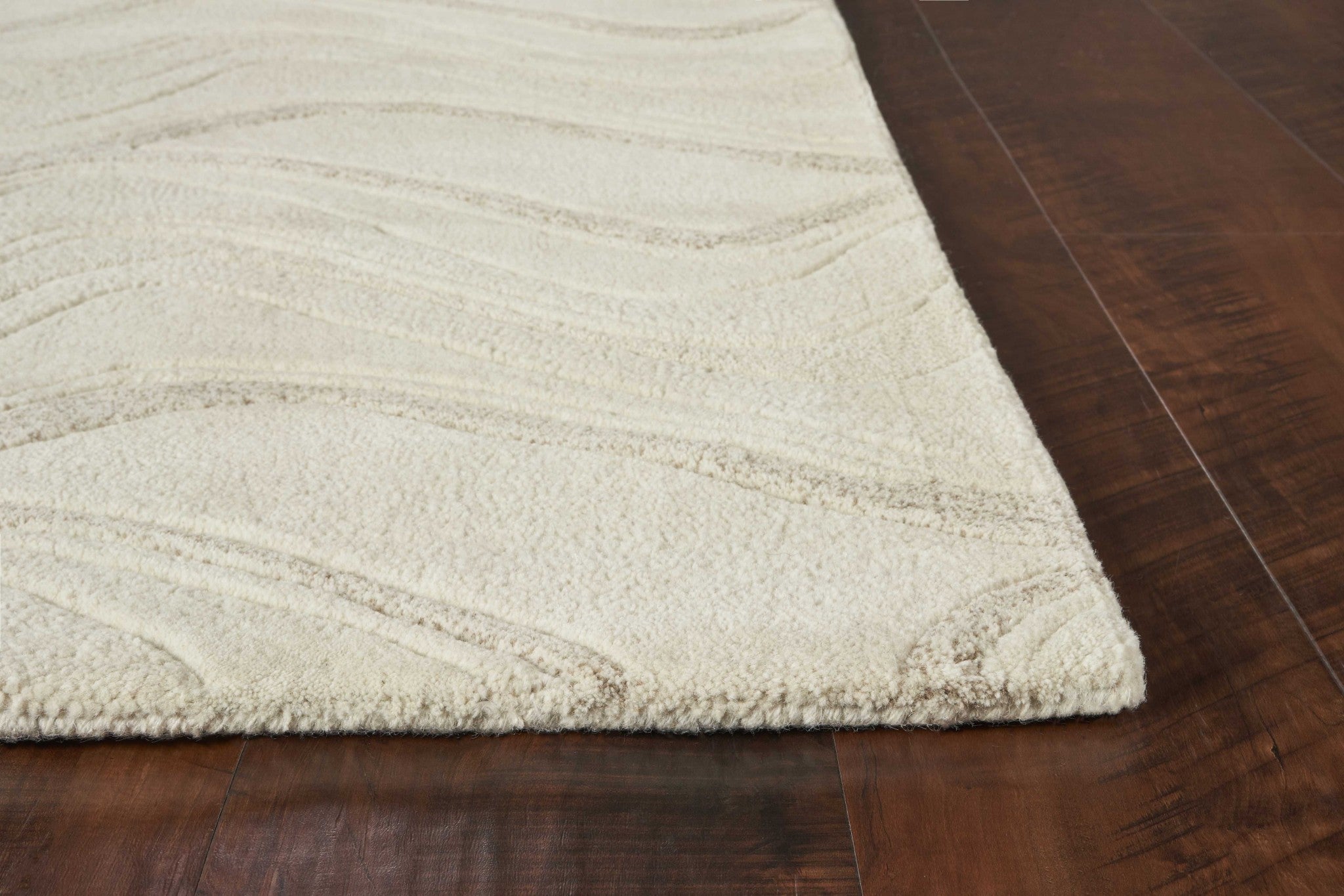 A luxurious 8x10 inches ivory wool area rug featuring elegant wave patterns, perfect for contemporary home decor.