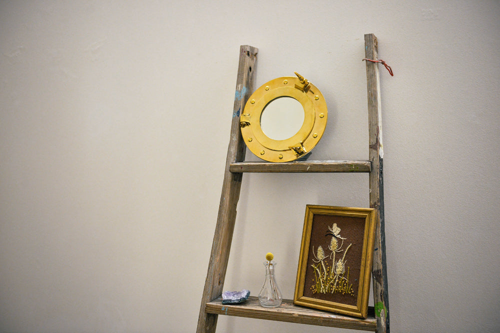 8x9.5 inch Porthole Mirror with solid brass frame and hinged design, perfect for nautical-themed decor.