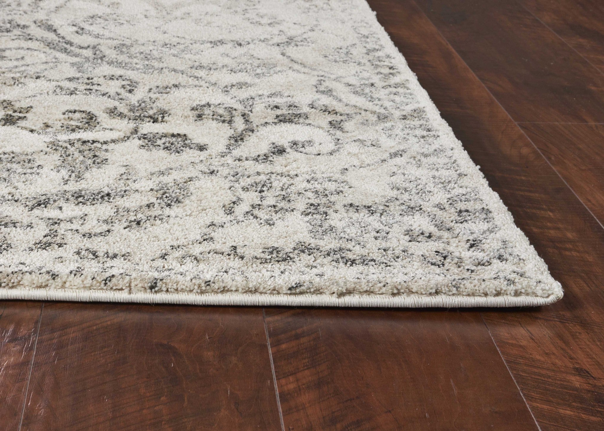 8x10 inches ivory machine woven rug featuring distressed floral vines design, perfect for indoor spaces.