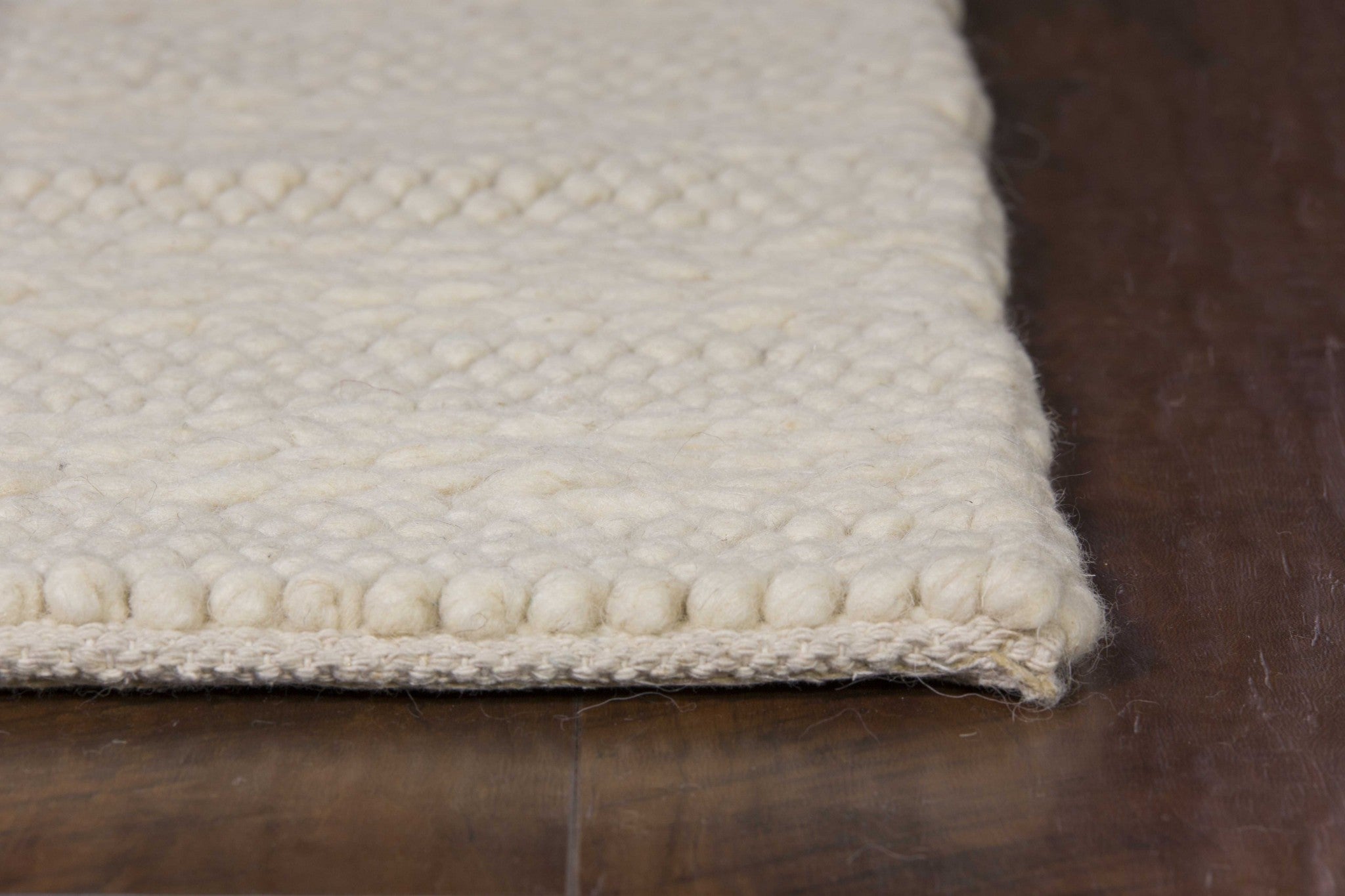 A luxurious 8x10 inches white ivory hand woven knobby rug featuring a Cornish stripe pattern, perfect for indoor decor.