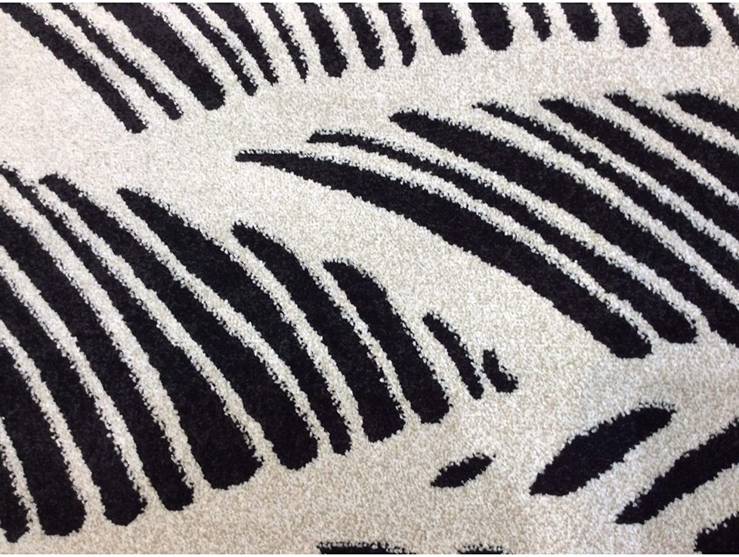 8x11 inches black and white machine woven outdoor rug featuring tropical palm design, made of UV-treated polypropylene.