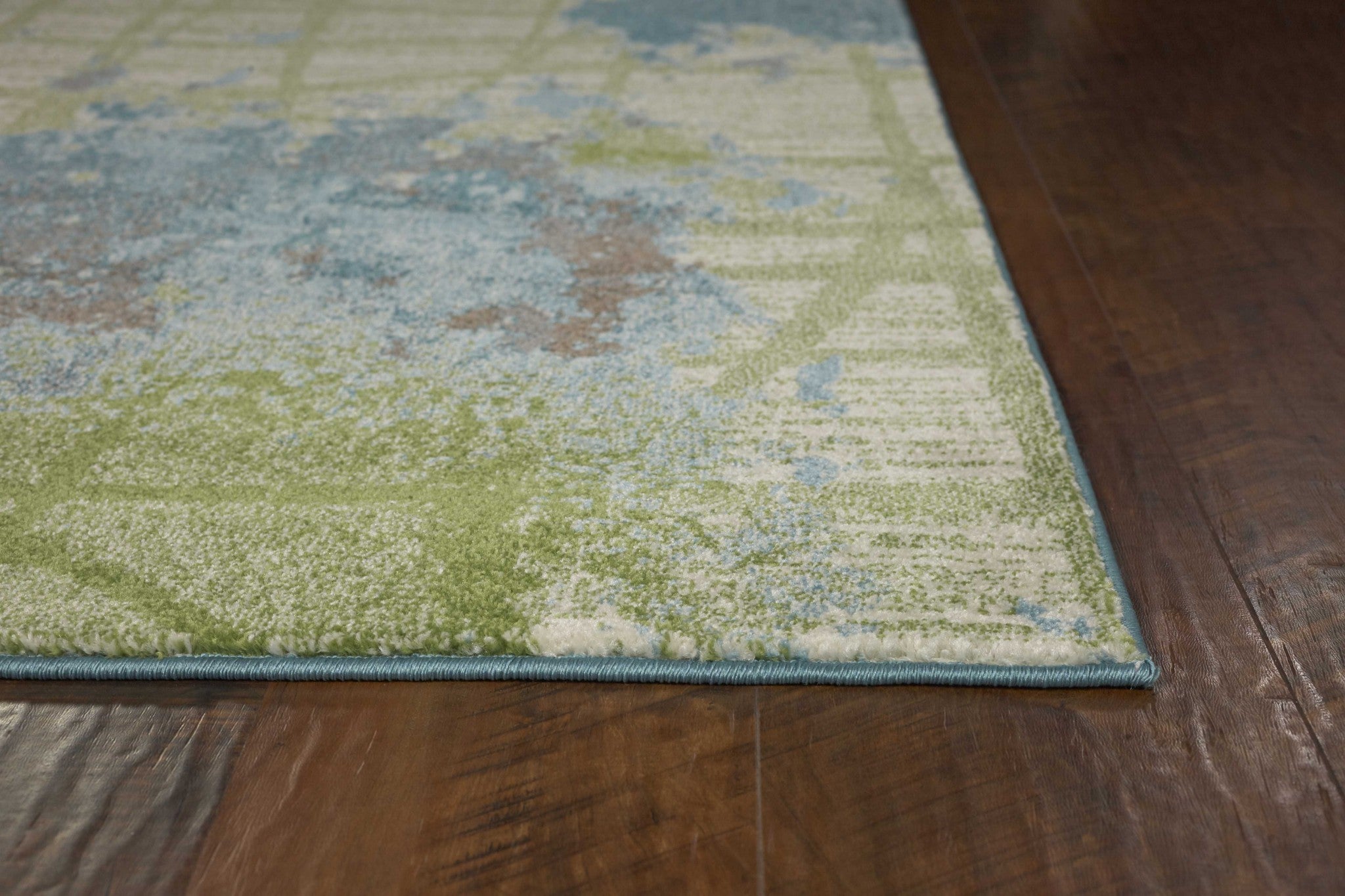 A vibrant green and blue abstract indoor area rug, machine woven, showcasing watercolor designs, perfect for contemporary home decor.